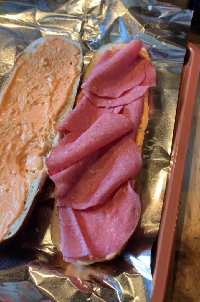 Carl Buddig beef slices layered on one half of the sliced loaf