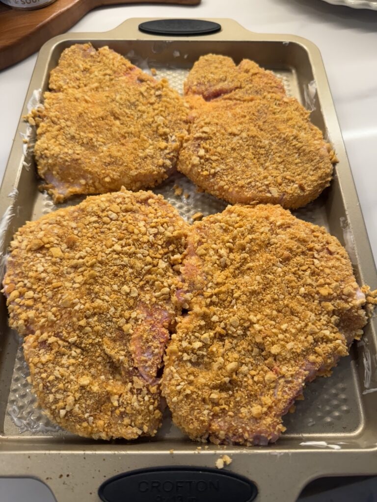 Four pork chops coated in Oven Fry