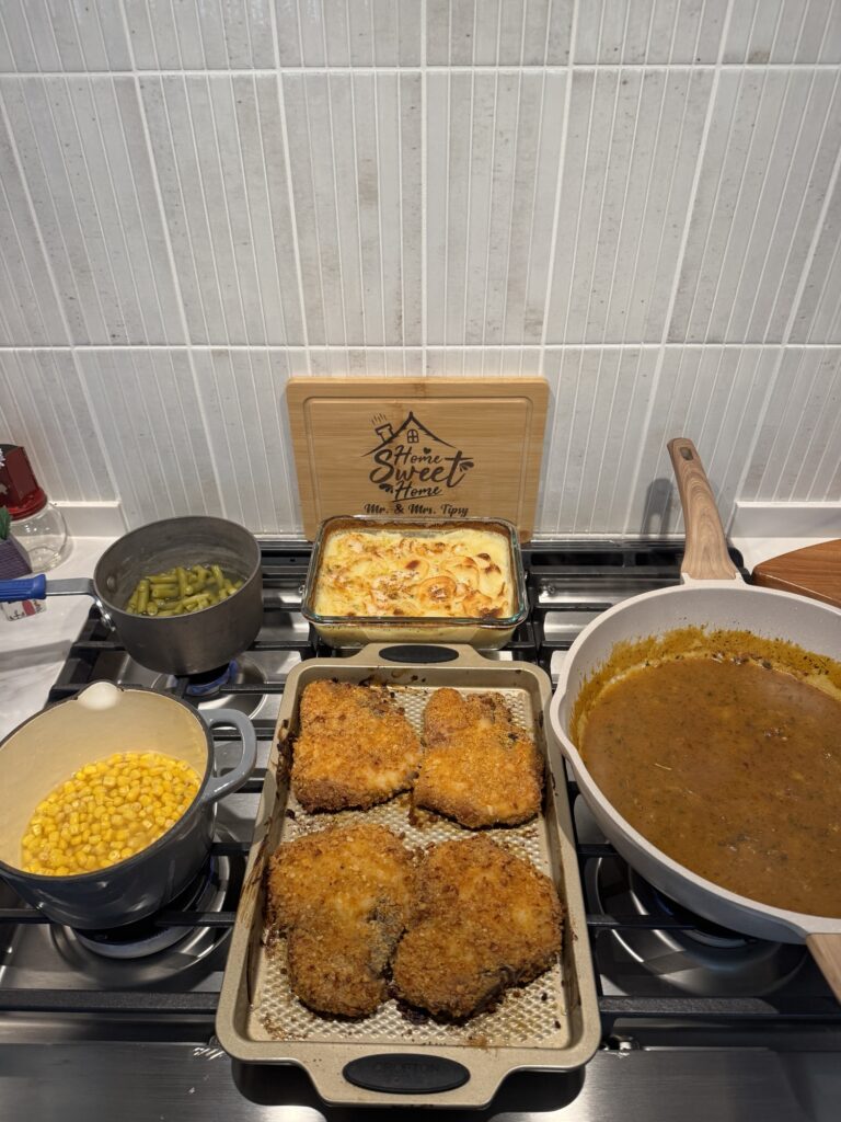The finished meal, including crispy chops, corn, green beans, potatoes, and gravy
