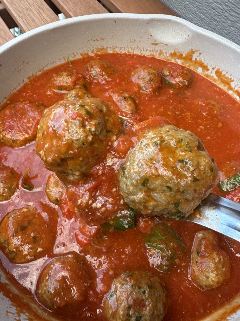 Two meatballs on a spoon