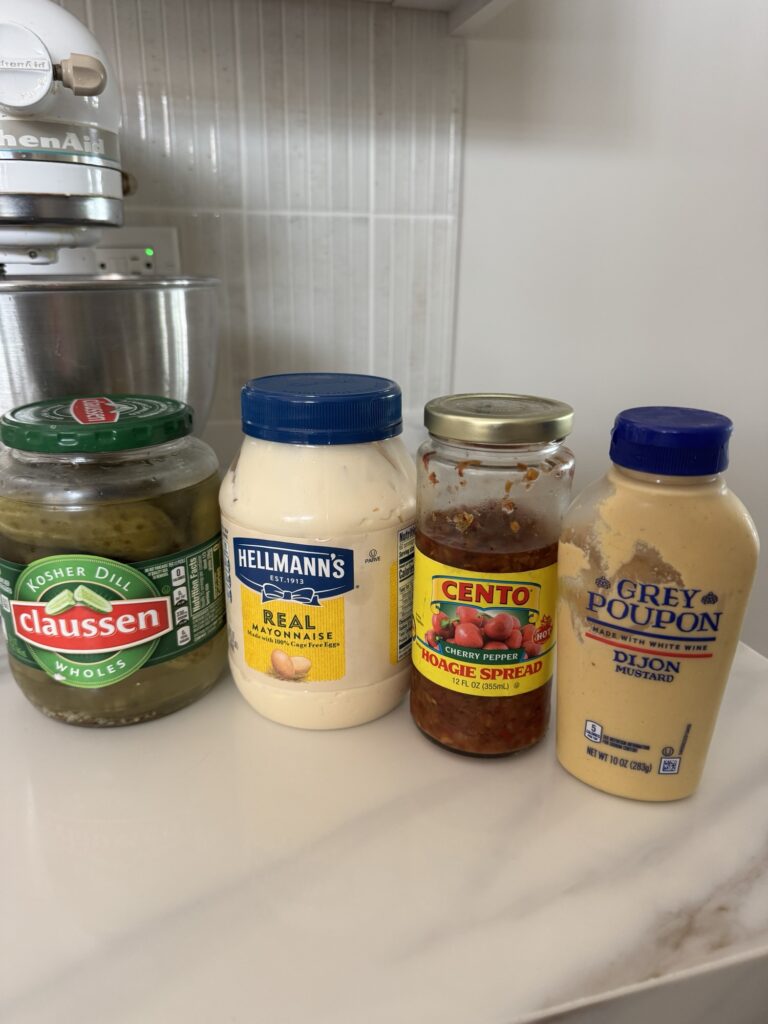Pickles, mayonnaise, cherry pepper hoagie spread, and mustard