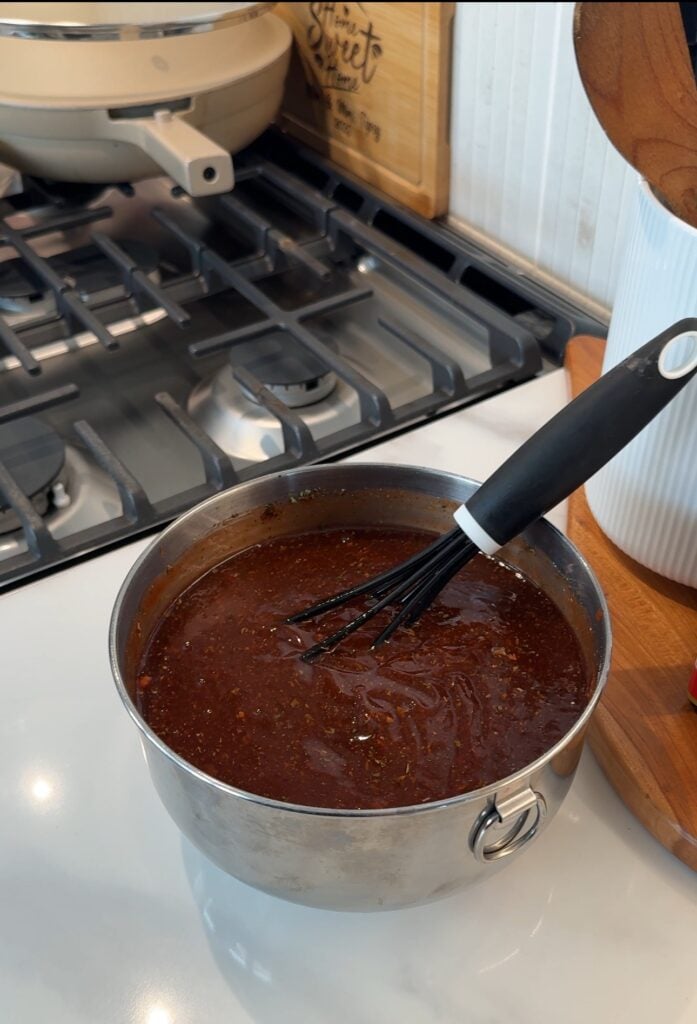 BBQ sauce in a pot with a whisk