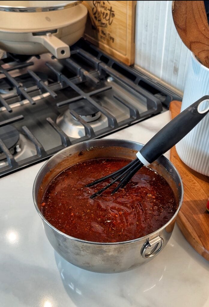 BBQ sauce in a pot with a whisk