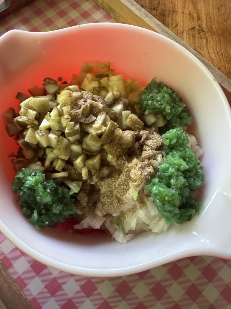 Celery salt added to the bowl of topping