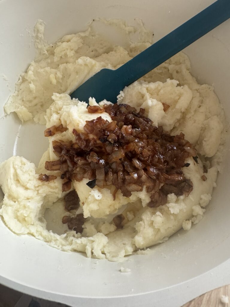 Cooked onions in the potato mixture