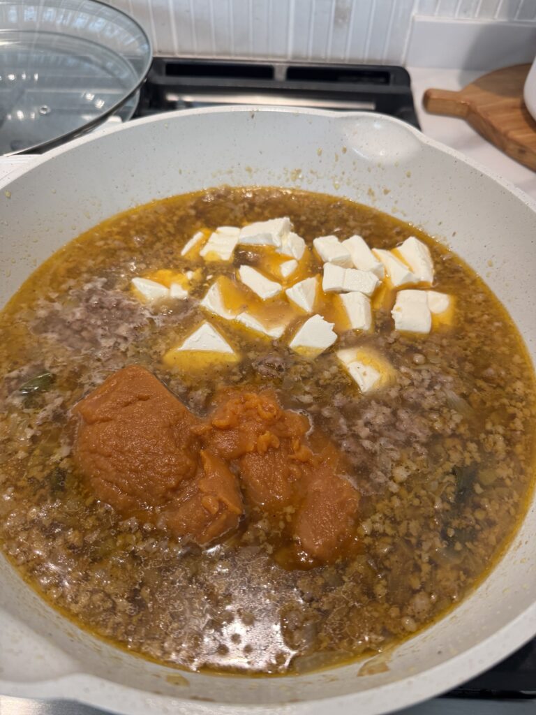 The pasta sauce ingredients in a pan